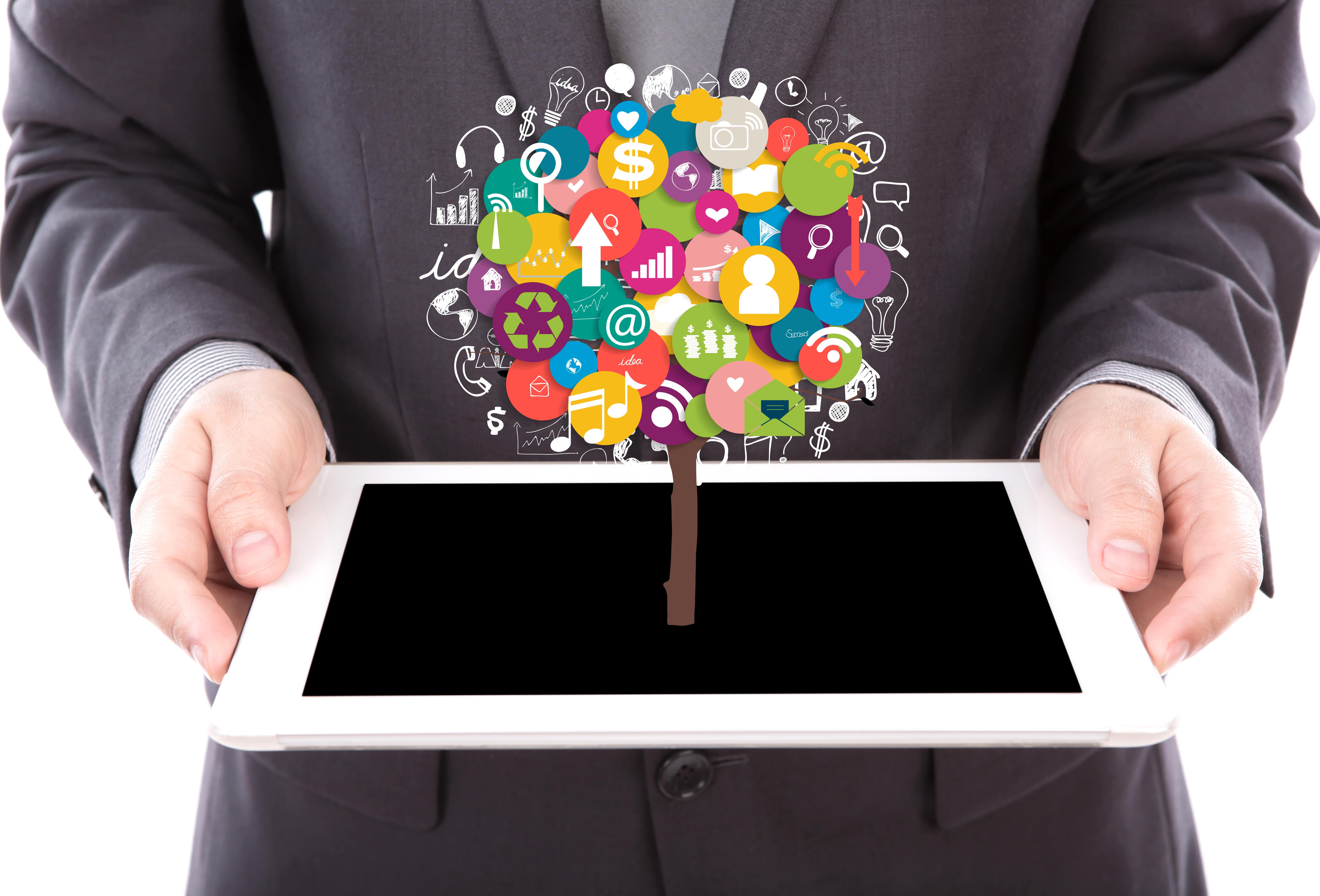 businessman-holding-tablet-with-colorful-icons-min